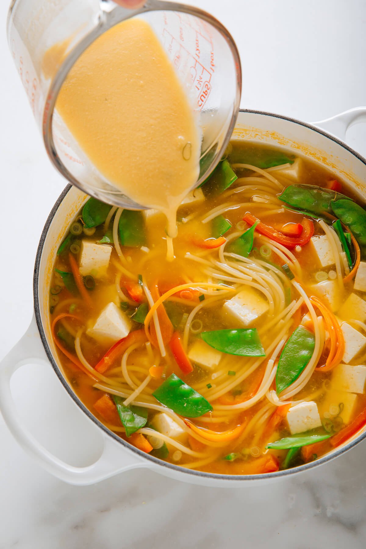 pouring miso mixture into soup