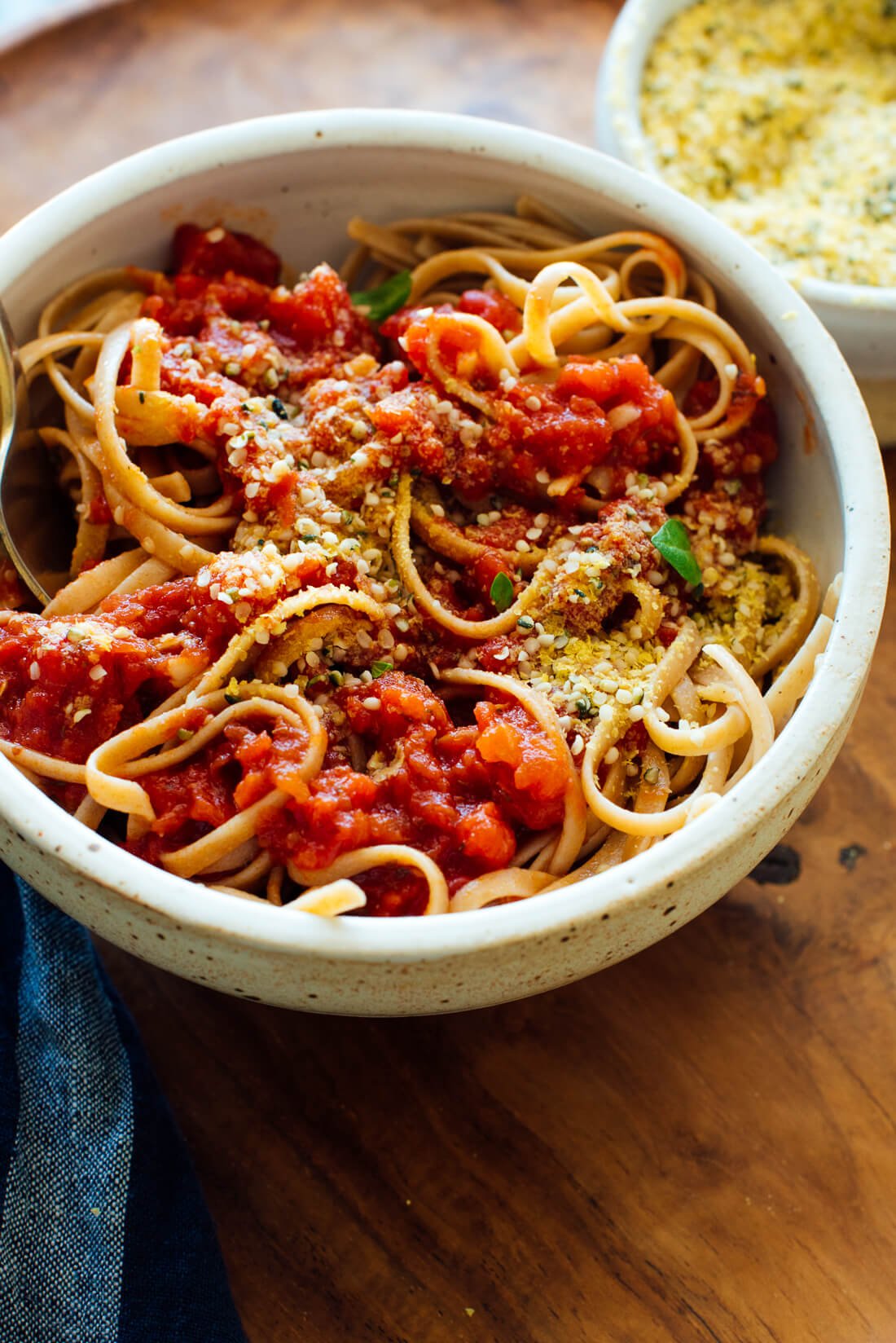 Vegan Parmesan cheese on spaghetti with marinara